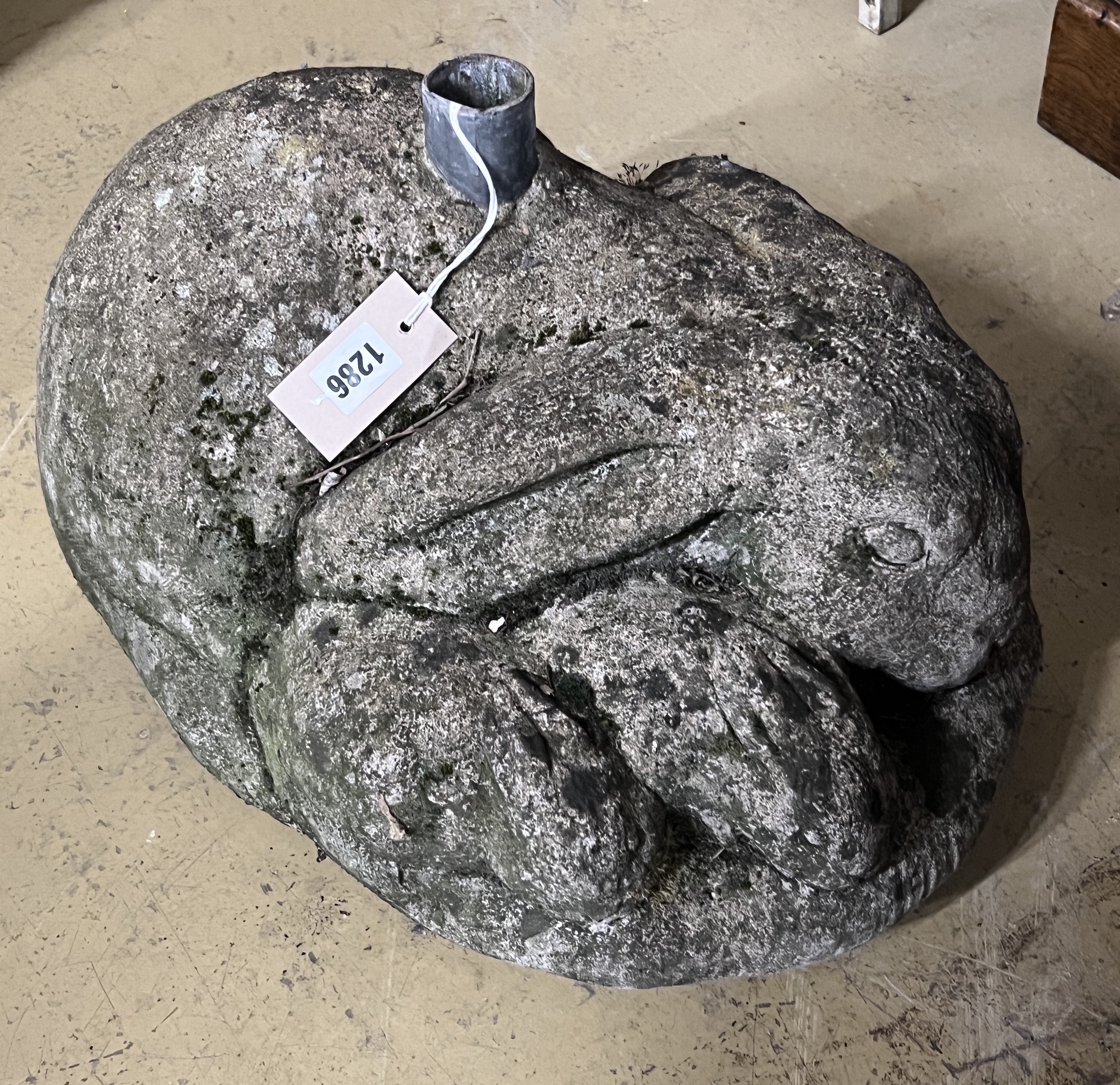 A reconstituted stone rabbit garden ornament, possibly a parasol base, width 48cm, height 30cm